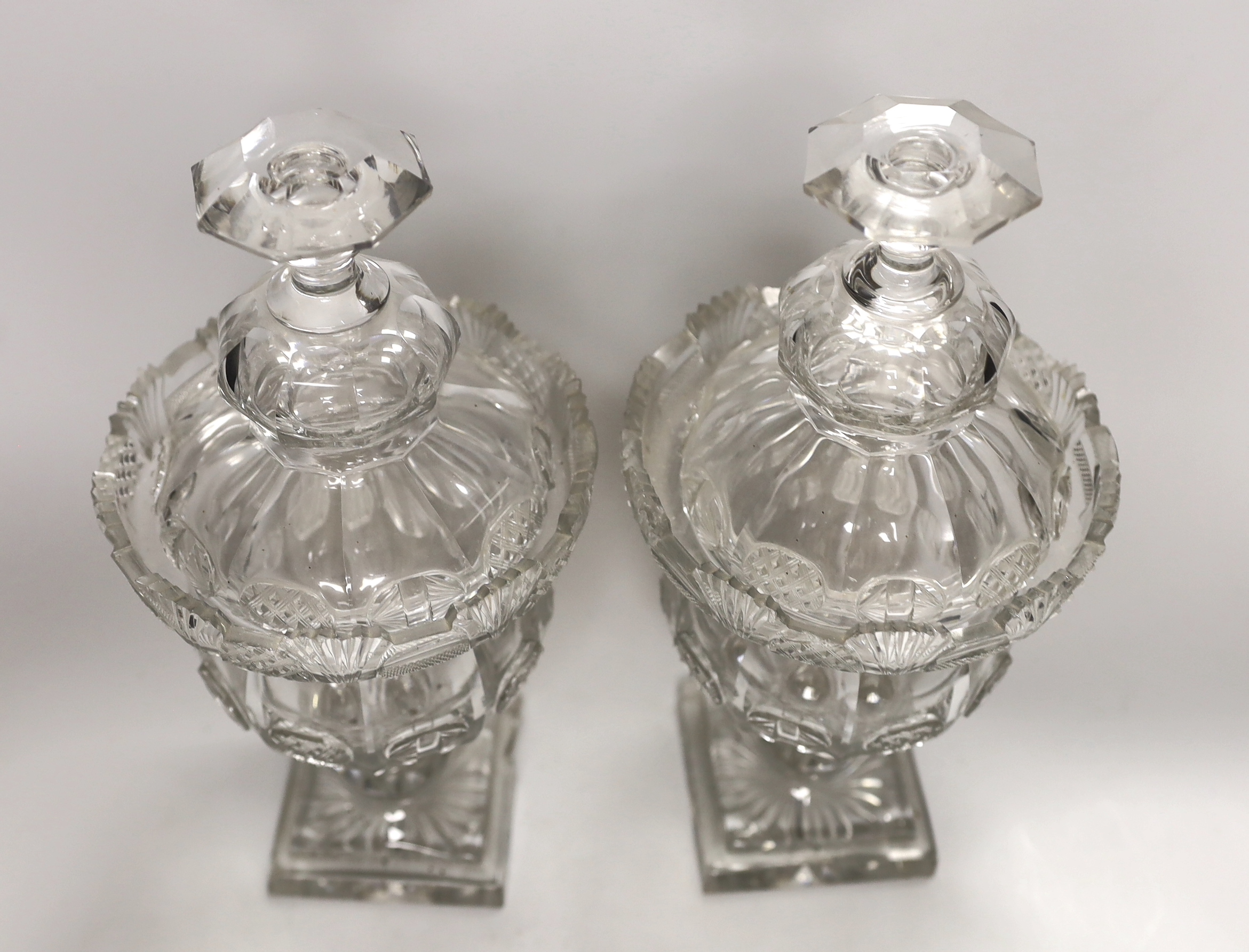 A pair of early Victorian cut glass pomade jars and covers, 30cm